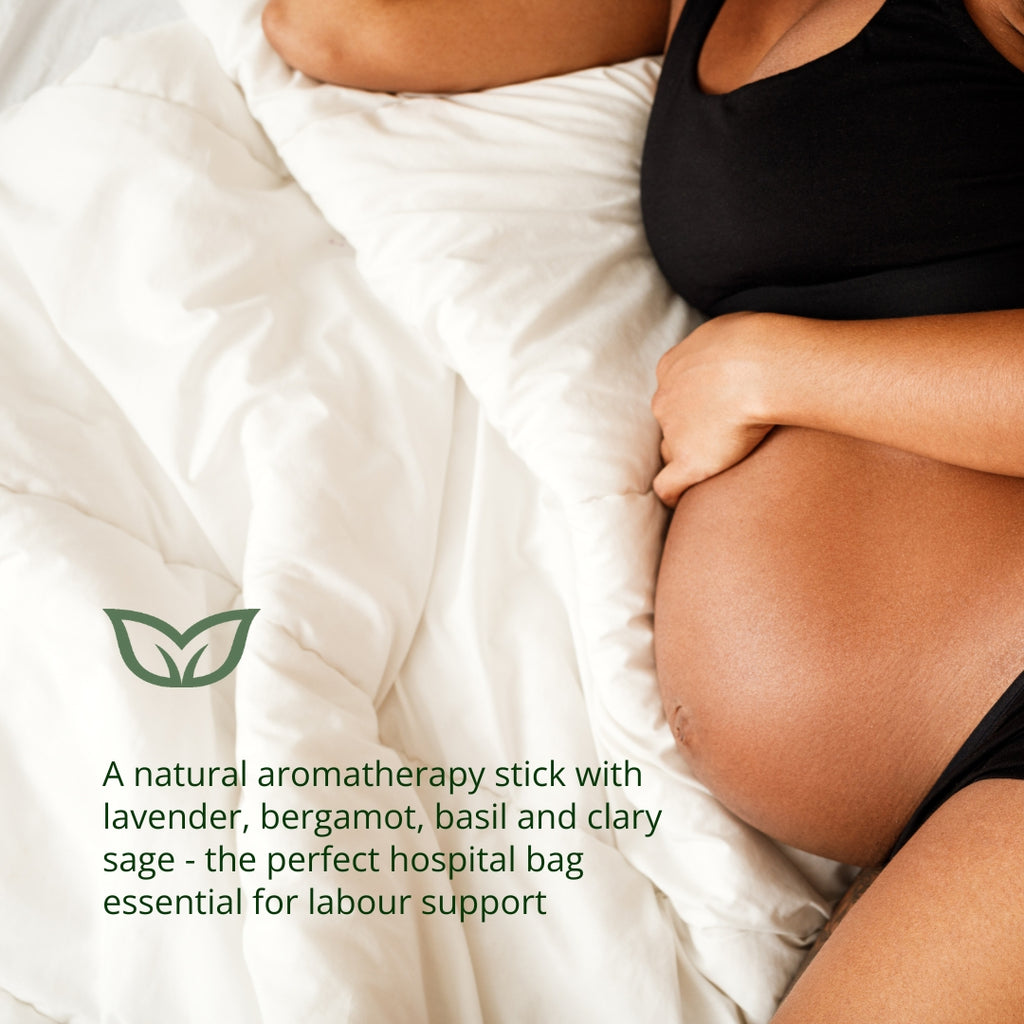 Pregnant woman preparing for labour with natural aromatherapy stick containing lavender, bergamot, basil and clary sage - the perfect hospital bag essential for labour support and natural childbirth preparation