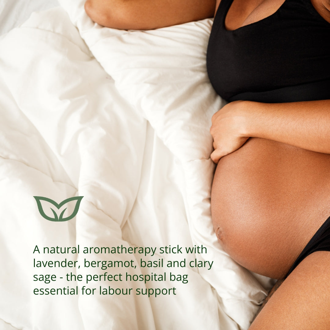 Pregnant woman preparing for labour with natural aromatherapy stick containing lavender, bergamot, basil and clary sage - the perfect hospital bag essential for labour support and natural childbirth preparation
