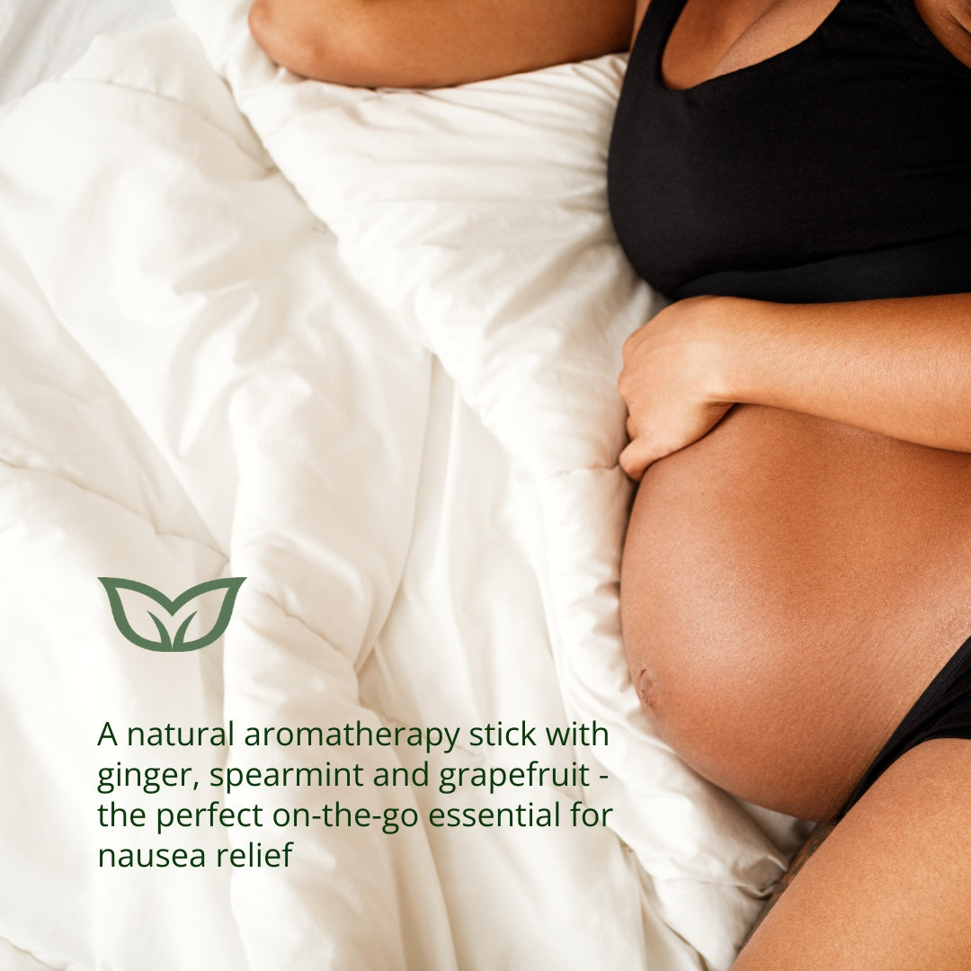 Pregnant woman using natural aromatherapy stick with ginger, spearmint and grapefruit for on-the-go morning sickness and nausea relief
